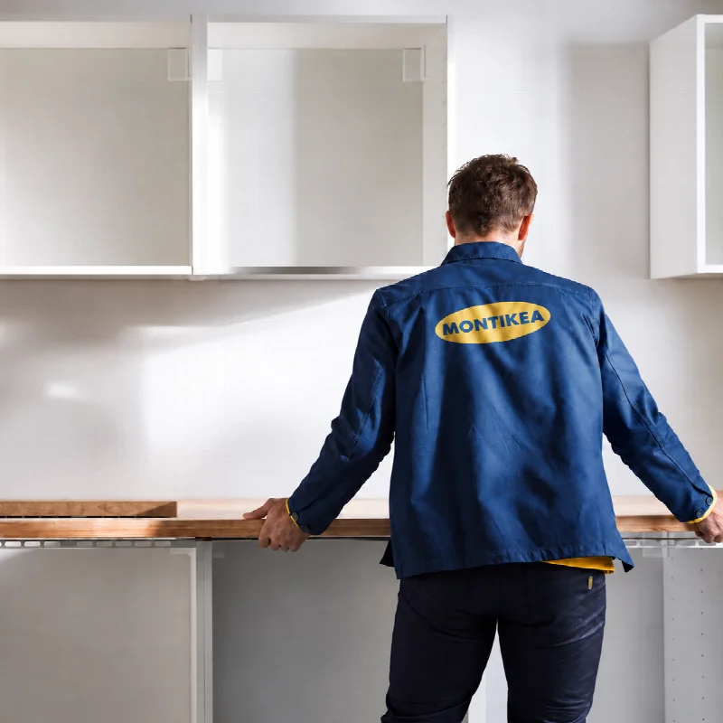 Installer wearing MONTIKEA workwear fitting a kitchen